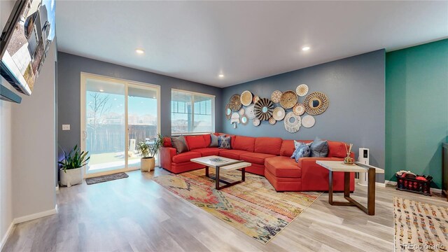 living room featuring recessed lighting, wood finished floors, and baseboards