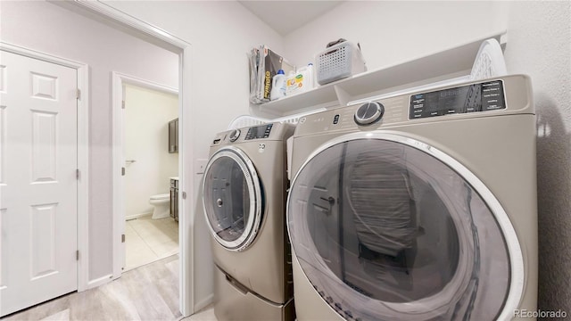 washroom featuring laundry area and washing machine and clothes dryer