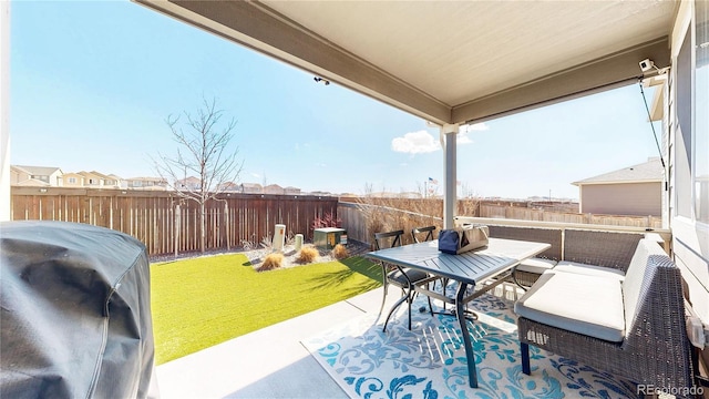 view of patio featuring outdoor lounge area, area for grilling, and a fenced backyard