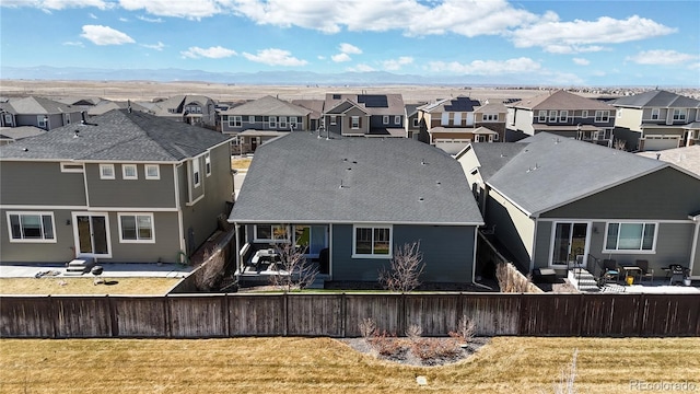 back of house featuring a residential view and a fenced front yard