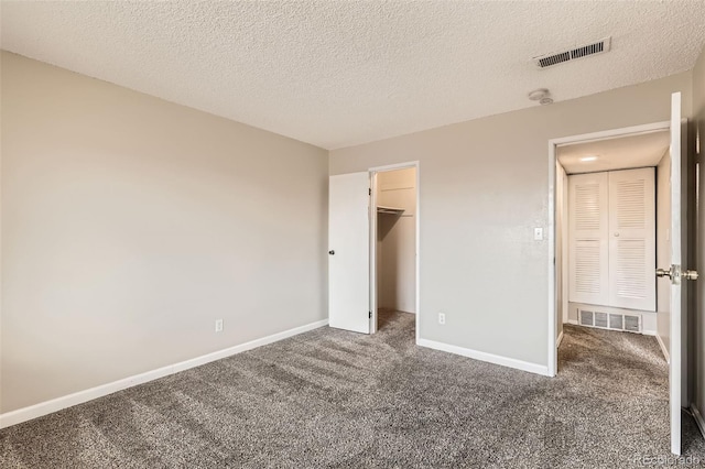 unfurnished bedroom with carpet flooring, visible vents, and baseboards