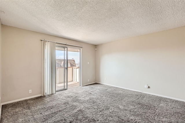 carpeted empty room with a textured ceiling and baseboards