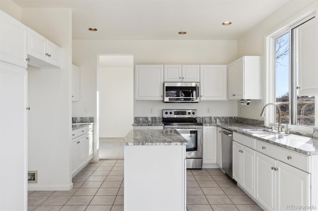 kitchen with white cabinets, a kitchen island, and appliances with stainless steel finishes