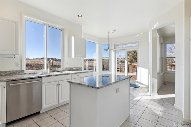 kitchen featuring dishwasher, white cabinets, decorative light fixtures, light tile patterned flooring, and light stone counters