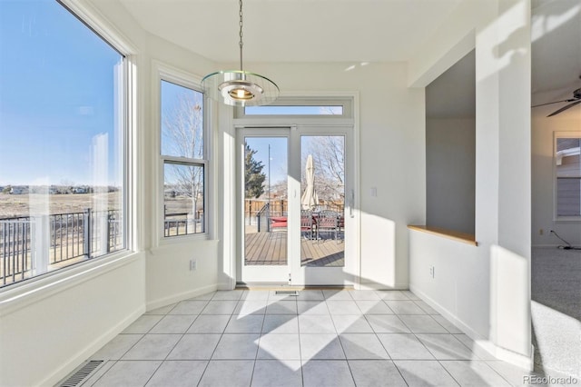 interior space with ceiling fan