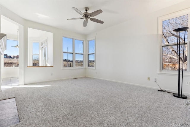 empty room featuring carpet flooring and ceiling fan