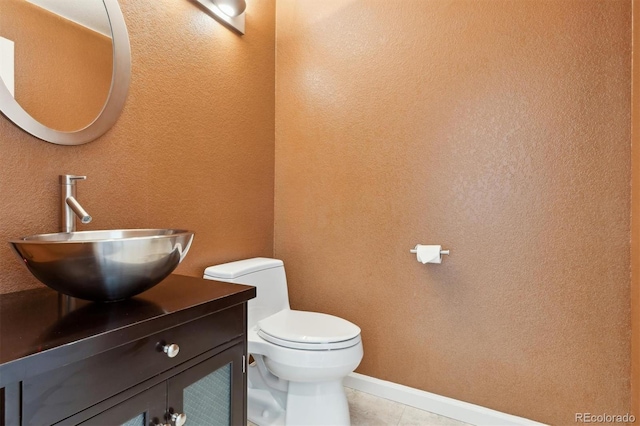 bathroom with tile patterned floors, vanity, and toilet