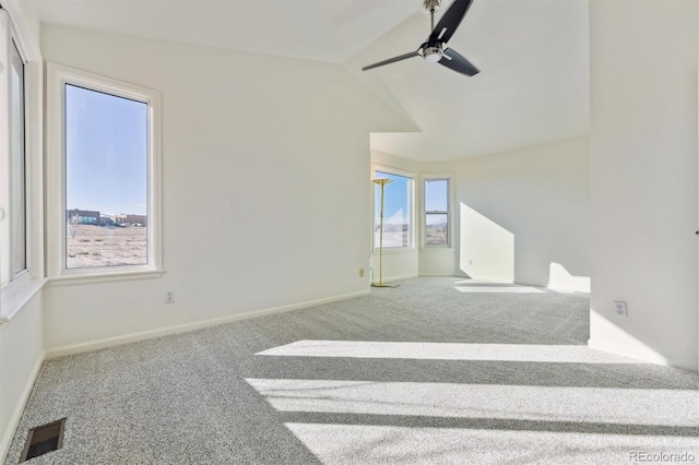 carpeted empty room with ceiling fan and lofted ceiling