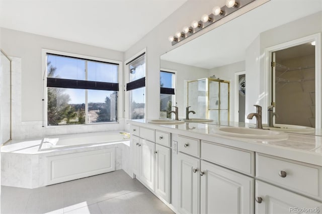 bathroom featuring tile patterned floors, vanity, and shower with separate bathtub