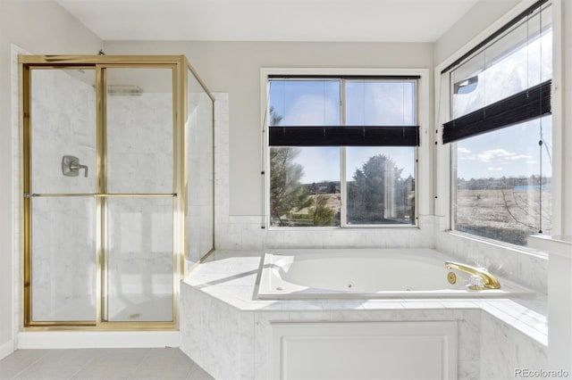 bathroom featuring tile patterned flooring and separate shower and tub