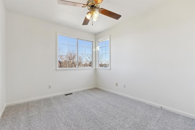 carpeted empty room featuring ceiling fan