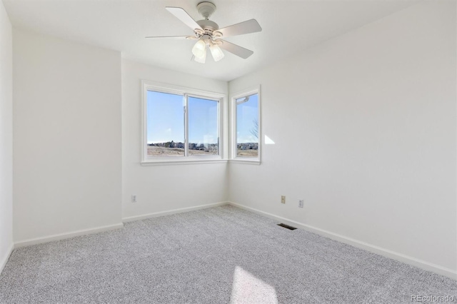 empty room featuring carpet flooring and ceiling fan