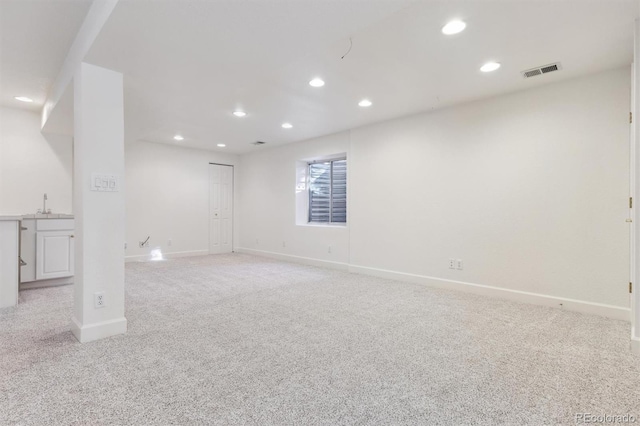 carpeted spare room featuring sink