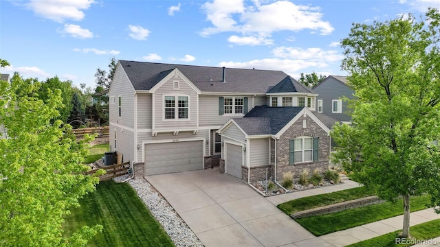 6040 Virgil St, Arvada, CO 80403 - view of front of house featuring concrete driveway, cooling unit, brick siding, an attached garage, and a front lawn