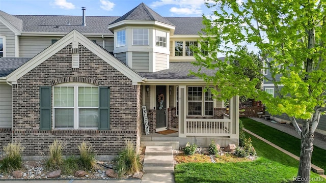 6040 Virgil St, Arvada, CO 80403 - view of front facade with brick siding and roof with shingles