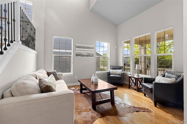 6040 Virgil St, Arvada, CO 80403 - living area with high vaulted ceiling, wood finished floors, stairs, and baseboards