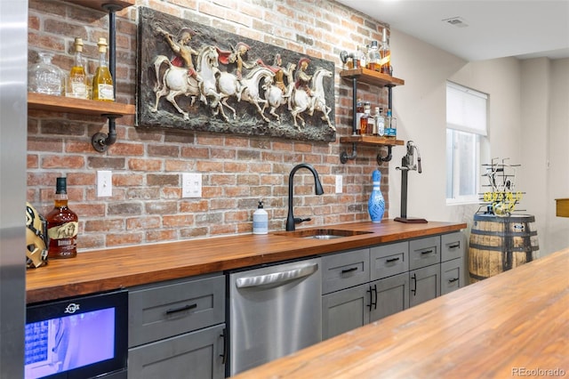 6040 Virgil St, Arvada, CO 80403 - indoor wet bar featuring stainless steel dishwasher and brick wall