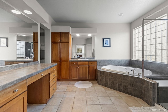 6040 Virgil St, Arvada, CO 80403 - bathroom featuring a garden tub, vanity, tile patterned flooring, and recessed lighting
