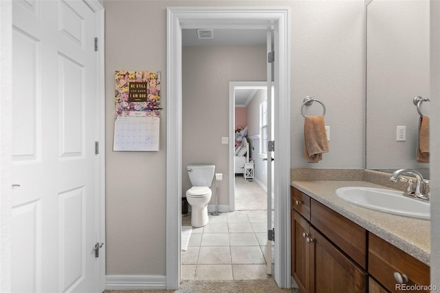 6040 Virgil St, Arvada, CO 80403 - bathroom with vanity, toilet, tile patterned floors, and baseboards