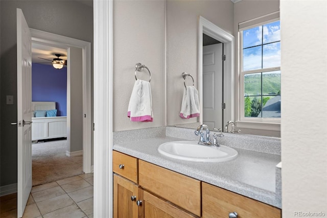 6040 Virgil St, Arvada, CO 80403 - bathroom with tile patterned flooring, vanity, a ceiling fan, and baseboards