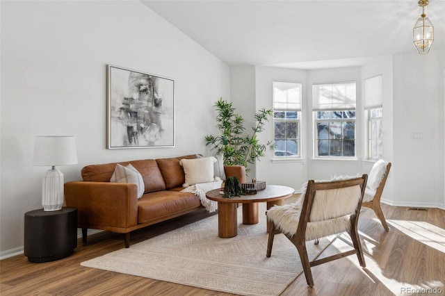 sitting room with an inviting chandelier and hardwood / wood-style floors