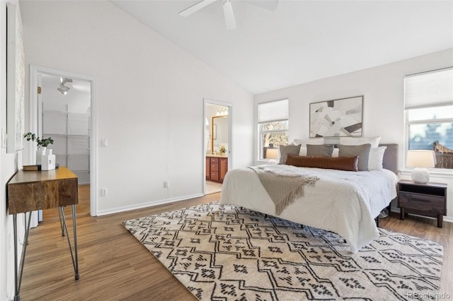 bedroom featuring wood-type flooring, high vaulted ceiling, ceiling fan, and ensuite bathroom