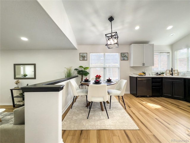 dining space featuring sink and light hardwood / wood-style flooring