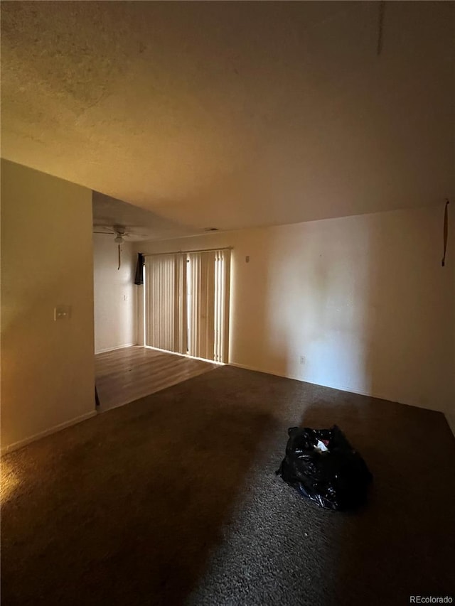 spare room with carpet flooring and a textured ceiling