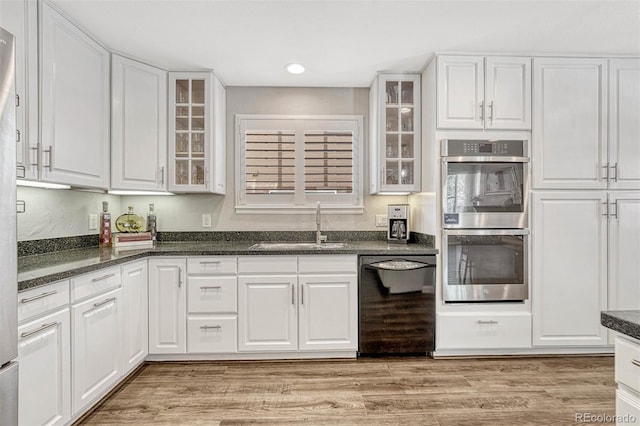 kitchen featuring stainless steel double oven, white cabinetry, and dishwasher