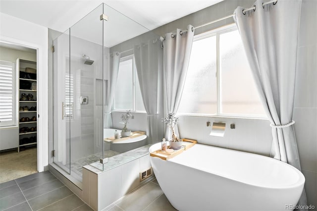 bathroom featuring independent shower and bath and tile patterned floors