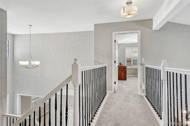 corridor featuring beamed ceiling, carpet, and a notable chandelier