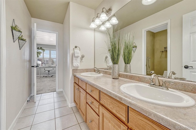 bathroom featuring tile patterned flooring, vanity, and toilet