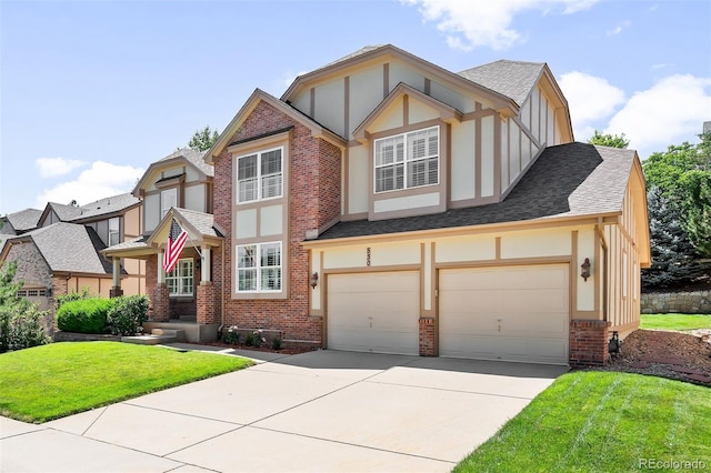 tudor home with a garage and a front yard