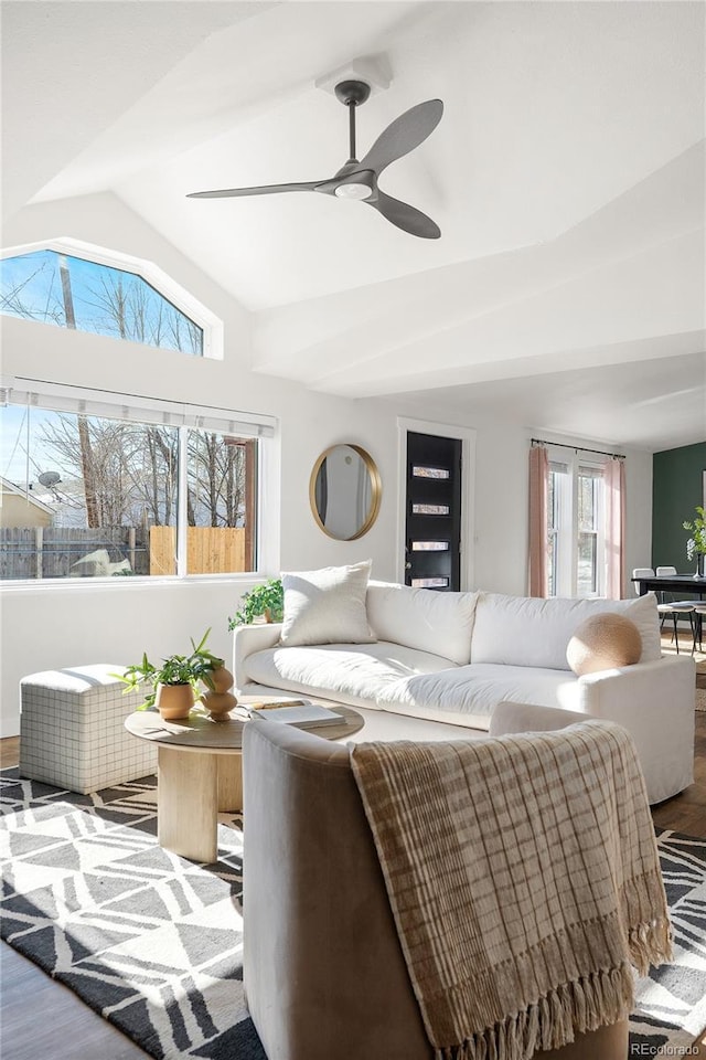 living room with ceiling fan, lofted ceiling, and hardwood / wood-style floors