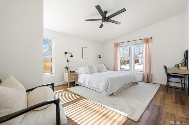 bedroom with lofted ceiling, dark hardwood / wood-style floors, and ceiling fan