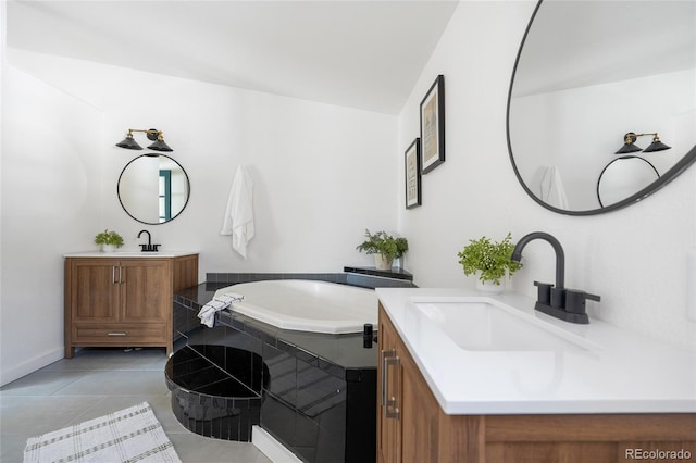 bathroom with vanity, tile patterned floors, tiled bath, and lofted ceiling