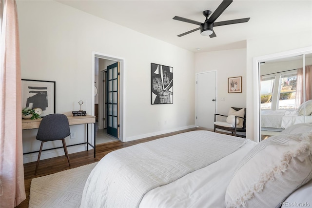 bedroom with connected bathroom, hardwood / wood-style floors, and ceiling fan