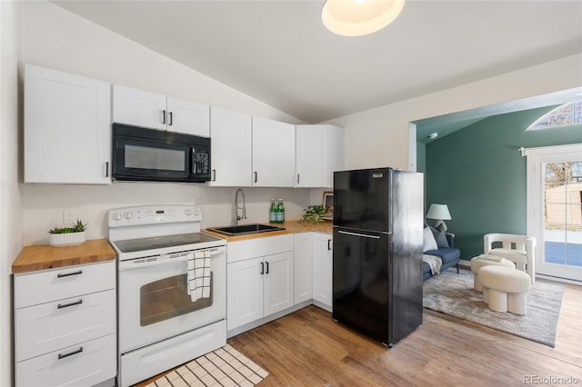 kitchen with white cabinetry, lofted ceiling, sink, butcher block counters, and black appliances