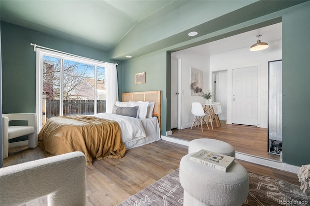 bedroom with hardwood / wood-style flooring and vaulted ceiling