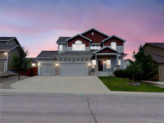 12420 Mount Belford Way, Peyton, CO 80831 - view of front of house featuring driveway, board and batten siding, a yard, and stone siding