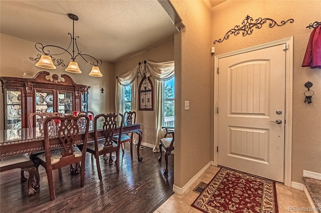 12420 Mount Belford Way, Peyton, CO 80831 - dining space featuring a textured ceiling, baseboards, a textured wall, and light tile patterned floors