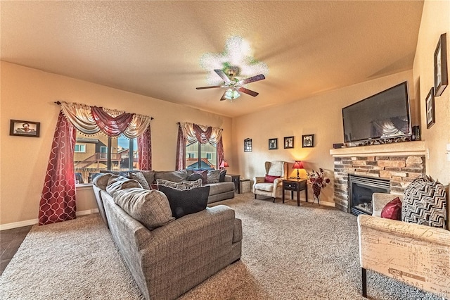 12420 Mount Belford Way, Peyton, CO 80831 - carpeted living room featuring a ceiling fan, a stone fireplace, a textured ceiling, and baseboards