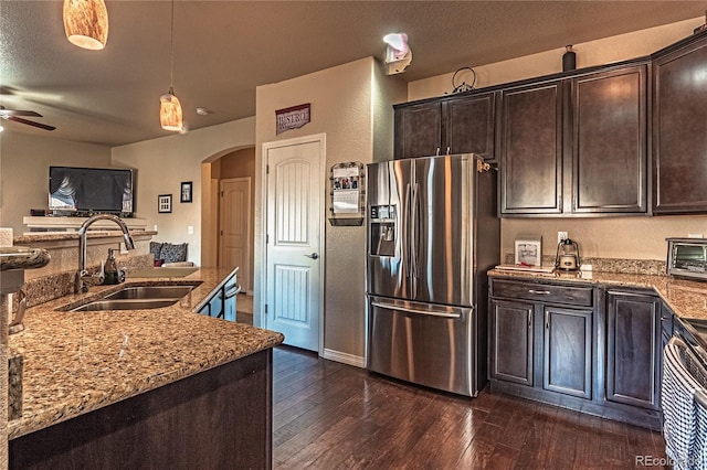 12420 Mount Belford Way, Peyton, CO 80831 - kitchen with stainless steel refrigerator with ice dispenser, a sink, arched walkways, a ceiling fan, and light stone countertops