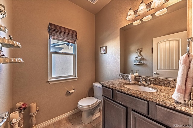 12420 Mount Belford Way, Peyton, CO 80831 - bathroom with toilet, vanity, tile patterned flooring, a textured wall, and baseboards