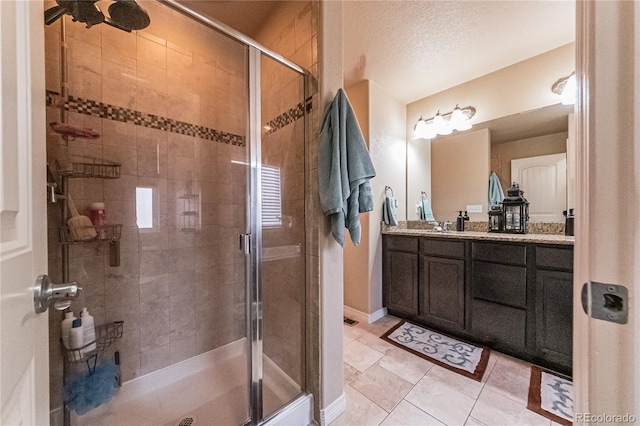 12420 Mount Belford Way, Peyton, CO 80831 - full bathroom featuring vanity, a stall shower, tile patterned floors, and baseboards