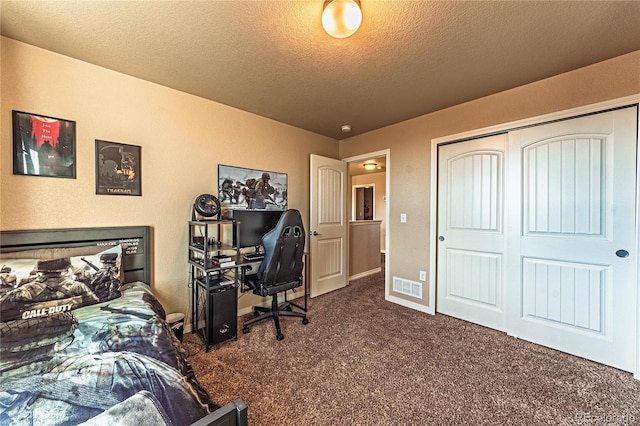 12420 Mount Belford Way, Peyton, CO 80831 - carpeted bedroom with a textured ceiling, an office area, baseboards, and a closet