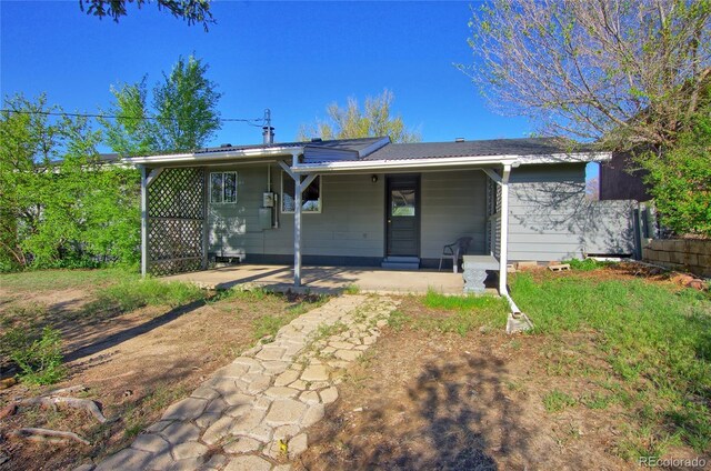 1227 Holmes Dr, Colorado Springs, CO 80909 - back of house with a porch