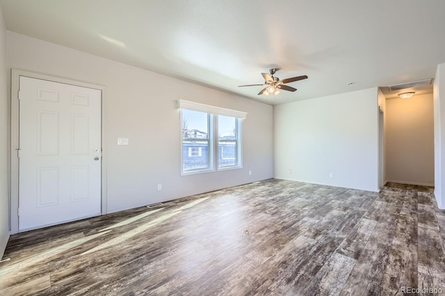 unfurnished room with ceiling fan and dark wood-type flooring