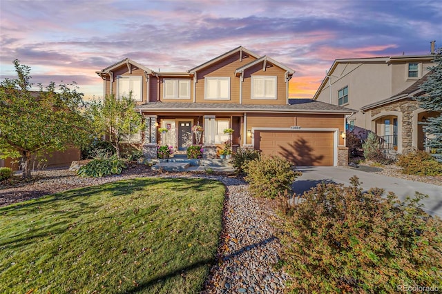 craftsman-style house featuring a garage and a yard