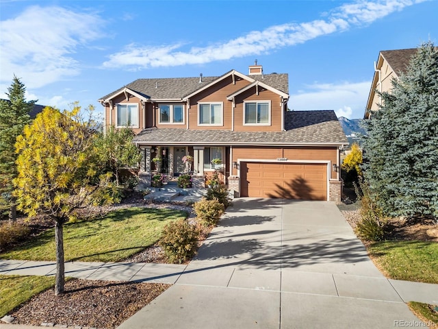 craftsman-style house featuring a garage and a front lawn